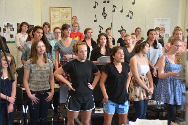 Scituate High School chorus students rehearsing.