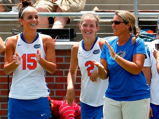 Florida head coach Amanda O'Leary will lead the Gators into the final four Friday against Syracuse in Stony Brook, N.Y. Juniors Sam Farrell (15) and Emily Dohony look on during a 15-2 win against Penn State over the weekend.