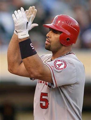 Los Angeles Angels' Albert Pujols celebrates after hitting a home run off Oakland Athletics' Graham Godfrey in the third inning of a baseball game, Tuesday, May 22, 2012, in Oakland, Calif. (AP Photo/Ben Margot)