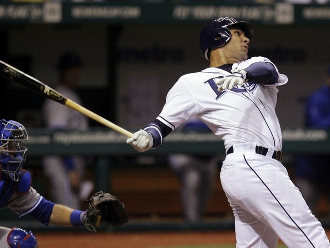 Tampa Bay Rays' Carlos Pena follows his fourth-inning, three-run home run off Toronto Blue Jays starting pitcher Drew Hutchison during a baseball game, Tuesday, May 22, 2012, in St. Petersburg, Fla. Catching for Toronto is J.P. Arencibia.