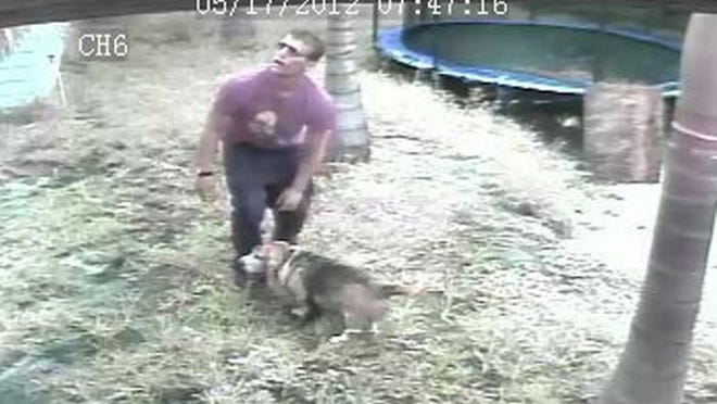 One of the suspects is seen befriending the victim's dog in the backyard of their home.