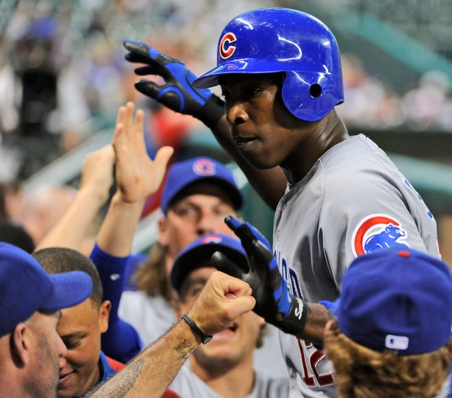 Chicago Cubs' Alfonso Soriano is welcomed back to the dugout after hitting a solo homer against the Houston Astros in the fourth inning of a baseball game, Tuesday, May 22, 2012, in Houston.