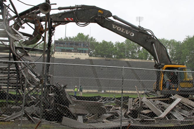 A mechanical claw begins dismantling the Memorial Stadium visiting bleachers Tuesday in Storrs. The demolition of the stadium, where UConn played football from 1953-2002, is expected to be completed in June. The site will hold the basketball practice facility.