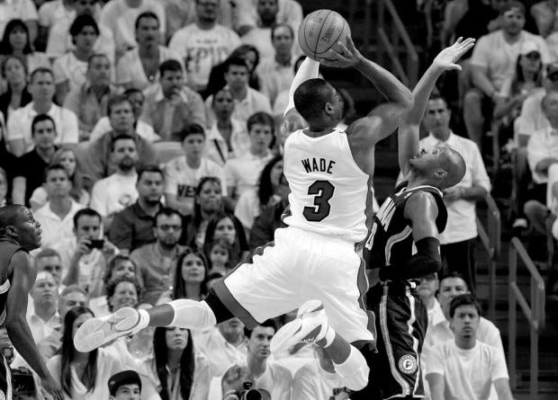 Miami Heat's Dwyane Wade (3) shoots over Indiana Pacers' Leandro Barbosa during the first half of Game 5 of their Eastern Conference semifinal playoff series on Tuesday in Miami. (AP PHOTO/LYNNE SLADKY)