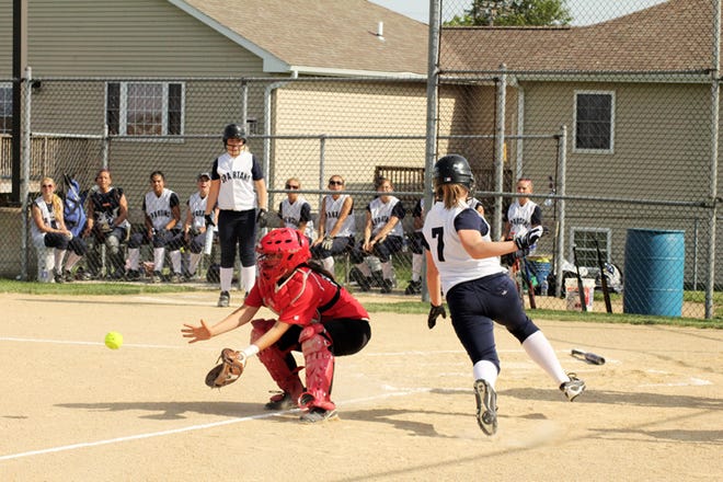 Ridgewood's Morgan Green, right, beats the ball to the plate to give her team a 2-0 lead in the top of the first inning during the regional opener with Orion on Monday, May 14, at Charger Field.