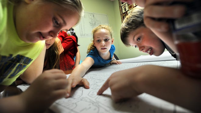 Third-graders from Upton's Memorial Elementary School participated in a mock town meeting and toured offices during "town government day" at Upton Town Hall. 
A group that included Brooke Glasier, left, Elizabeth Howell, center, and Jacob Knowles look over a map of Upton in the Assessor's Office Mapping Room.