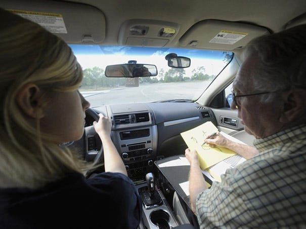 Ashley High School freshman student driver Hannah Dick takes driving cues from driver's education teacher Cecil Hobbs.