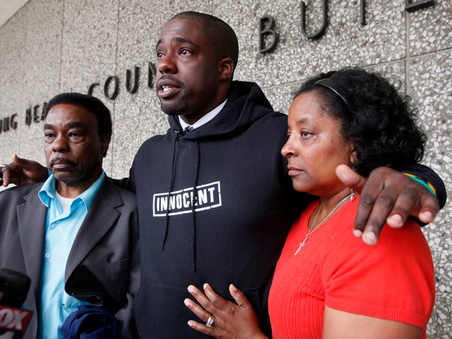 Brian Banks, center, reacts with his mother, Leomia Myers and father, Jonathan Banks, outside court after his rape conviction was dismissed Thursday May 24, 2012 in Long Beach, Calif. Banks, a former Long Beach high school football star and prized college recruit who served more than five years in prison for a rape he did not commit had his conviction overturned Thursday with his accuser recanting her story( AP Photo/Nick Ut)