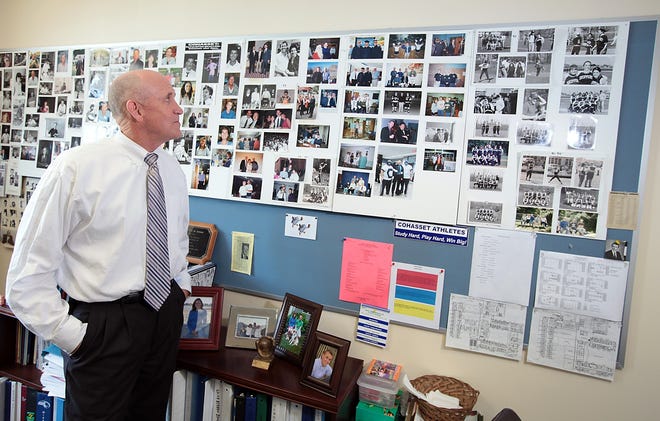 Principal Mike Gill looks over a board-full of memories collected over his 32 years in Cohasset.
