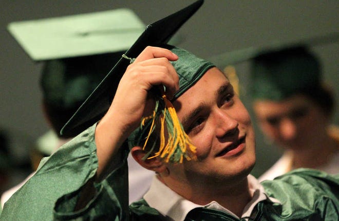 Darby Andress adjusts his tassel before New Deal High School's graduation ceremony on Friday in Lubbock. (Zach Long)