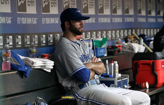Toronto Blue Jays starting pitcher Brandon Morrow sits in the dugout after he was pulled having given up six runs in the first inning against the Texas Rangers on Friday in Arlington. The Rangers went on to win, 14-3.