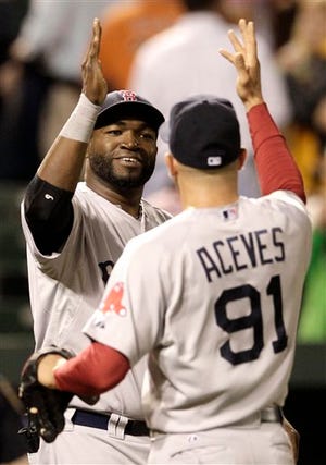 David Ortiz, seen high-fiving Alfredo Aceves, sparked the Red Sox latest hot streak when he called a players-only after the team took a drubbing at the hands of the Cleveland Indians. (AP Photo/Patrick Semansky)