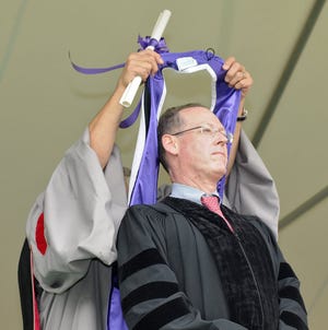 The 166th College of the Holy Cross Commencement. Keynote speaker Paul E. Farmer getting his Honorary Degree just prior to his address.