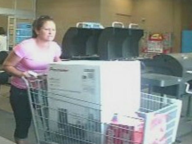 A woman is shown leaving Walmart with a stereo system and soda on May 19. (Photo courtesy Bradenton Police Department)
