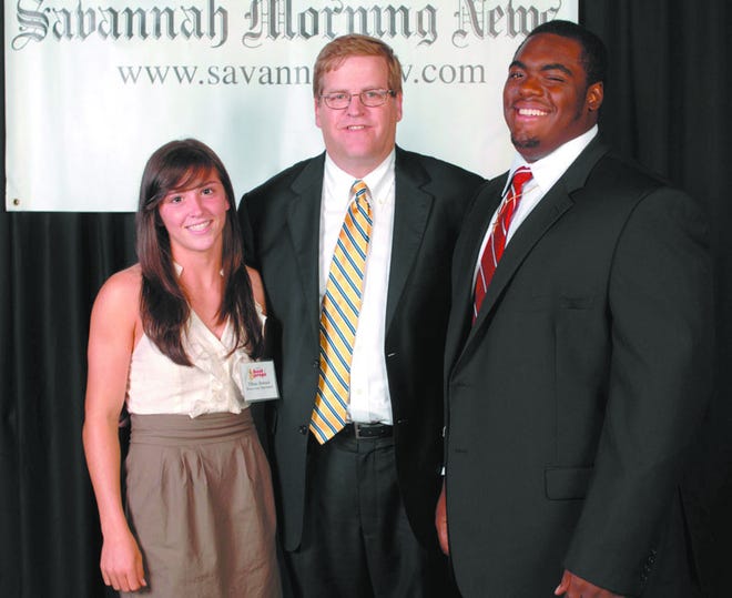 Savannah Morning News Publisher Michael C. Traynor stands with Female and Male Athletes of the Year Tiffany Howard, Bryan County High School, and DeAngelo Brown, Savannah Christian, during the 2012 Best of Preps Banquet at the Savannah International Trade and Convention Center Thursday night.
