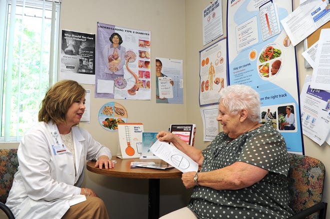 Certified diabetes educator Peggy Duffy speaks with diabetic patient Shirley St. John at Signature Healthcare Brockton Hospital.