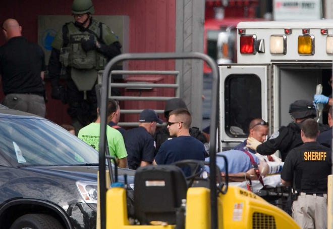 A gunman is placed into an ambulance after shooting himself twice during a police standoff at a Prudential Executive real estate building in Valparaiso, Indiana, on Friday.  Police say the gunman held employees hostage inside the building for several hours before releasing the last two unharmed. (AP Photo/The Times of Northwest Indiana, Jon L. Hendricks) CHICAGO OUT, GARY OUT, NO TV