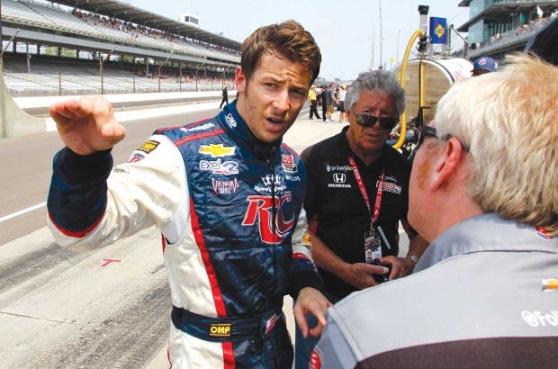 IndyCar driver Marco Andretti (left) talks with a member of his crew as his grandfather and 1969 Indy 500 champion Mario Andretti (center) looks on Friday after the final day of practice for the Indianapolis 500.(AP PHOTO/TOM STRATTMAN)