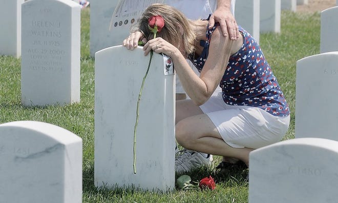 Violet Love visits the grave of her husband, Walter Gary Love, a Vietnam veteran,during Memorial Day services at the Washington Crossing National Cemetery.