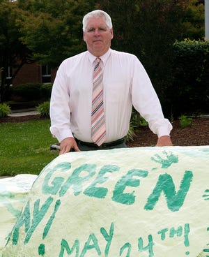 Ledford High School principal Bill Butts stands next to the school's 'spirit rock' that students paint for special occasions. Butts is retiring after a 30-year career in education.