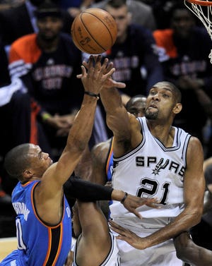 San Antonio Spurs center Tim Duncan (21) blocks a shot by Oklahoma City Thunder point guard Russell Westbrook (0) during Monday'sGame 1 in their NBA Western Conference finals playoff in San Antonio.