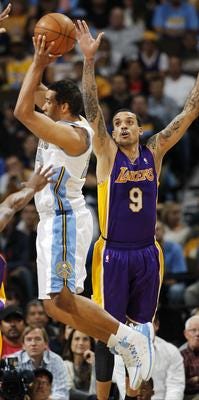Denver Nuggets guard Andre Miller, left, pulls in a loose ball as Los Angeles Lakers forward Matt Barnes covers in the first quarter of Game 4 of the teams' first-round NBA basketball series in Denver May 5. (AP Photo/David Zalubowski)