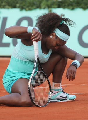 Serena Williams reacts shortly before losing to France's Virginie Razzano during their first-round match in the French Open on Tuesday.