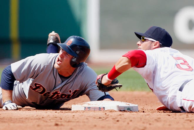 The Tigers' Danny Worth and Mike Aviles look up as Worth is called out at second base after trying to reach on a single in the third inning of the Red Sox' 7-4 victory on Monday afternoon at Fenway Park.