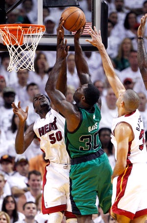 Below, Brandon Bass (middle) takes a shot against Miami’s Joel Anthony (left) and Shane Battier during Boston's loss to the Heat in Game 1 of the Eastern Conference finals.