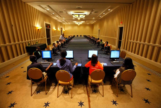 Contestants in the National Spelling Bee take the written exam on computers in Oxon Hill, Md., Tuesday, May 29, 2012. The oral competition begins Wednesday. (AP Photo/Jacquelyn Martin)