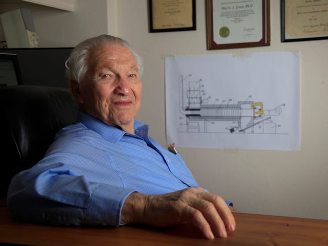 At 93, Alex Green of Green Liquid and Gas Technologies is marketing his Green Pyrolyzer machine, a device for turning advanced solid waste to energy by advanced thermal technology, shown with a drawing of his Beta arrangement model in his home office in Gainesville on May 21, 2012.