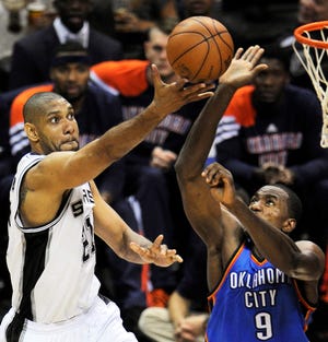 Oklahoma City Thunder's Serge Ibaka (9), from the Republic of Congo, blocks a shot by San Antonio Spurs center Tim Duncan (21) during the second half of Game 2 in their NBA basketball Western Conference finals playoff series, Tuesday, May 29, 2012, in San Antonio. (AP Photo/Darren Abate)