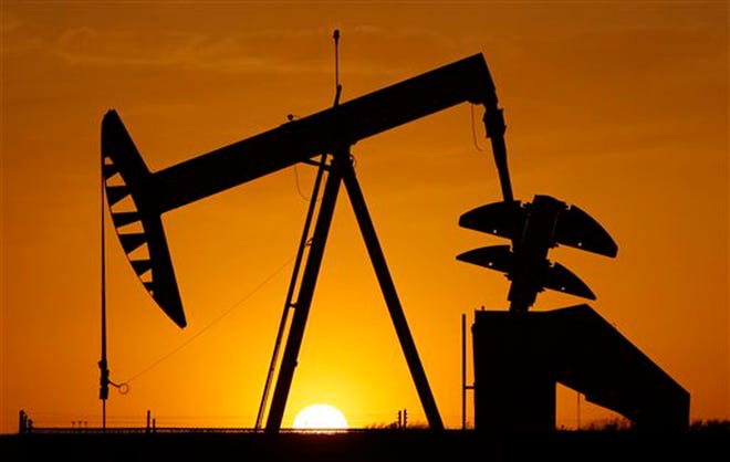In this Tuesday, March 22, 2012 file photo, a pump jack is silhouetted against the setting sun in Oklahoma City. Oil is headed for its worst month since December 2008. A financial crisis in Europe and slowing growth in China and the U.S. likely mean demand won't meet prior expectations. Oil fell 3 percent Wednesday and is down about 16 percent so far in May. (AP Photo/Sue Ogrocki, File)