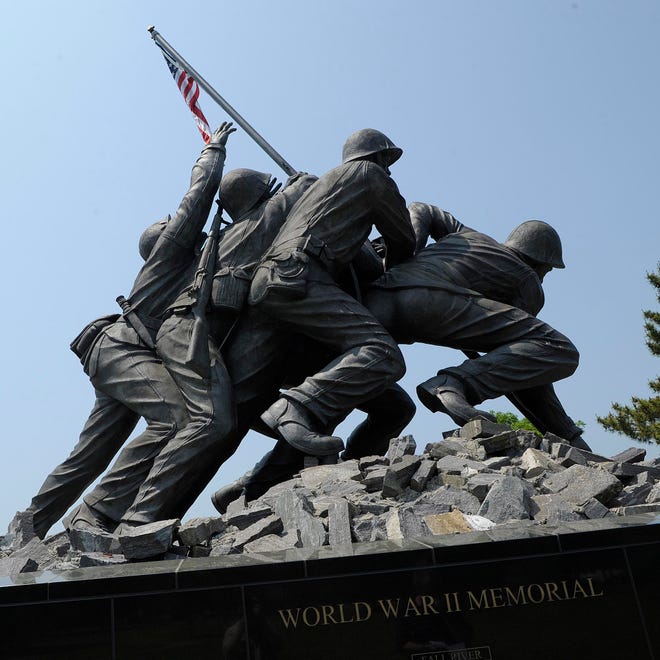 The new addition is mortared in above the word "memorial" and below the sculptured replica of Associated Press photographer Joe Rosenthal's iconic photograph of the flag raising at Iwo Jima.
