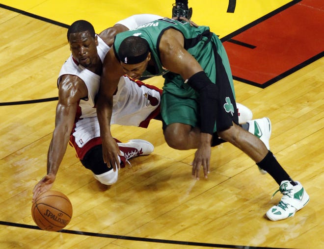 Miami Heat's Dwyane Wade (3) and Boston Celtics' Paul Pierce (34) go after a loose ball during the first half of Game 2 in their NBA basketball Eastern Conference finals playoffs series, Wednesday in Miami. (AP Photo/Wilfredo Lee)