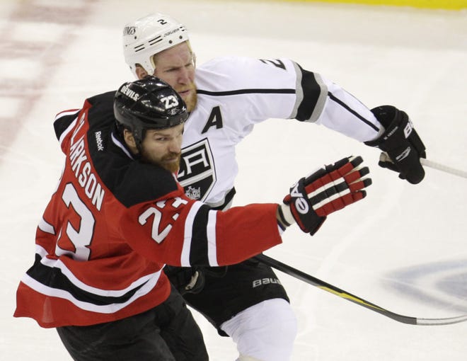 New Jersey Devils' David Clarkson (left) collides with Los Angeles Kings' Matt Greene during the first period of Game 1 of the NHL hockey Stanley Cup finals Wednesday in Newark, N.J. (AP Photo/Frank Franklin II)