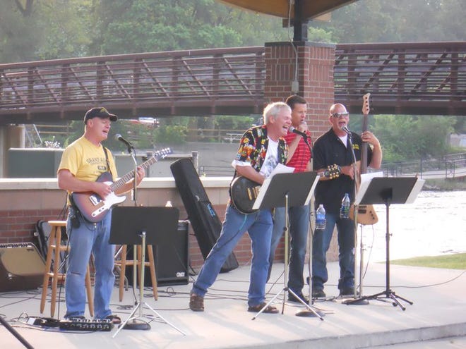 Brothers Jon Brown (left), Tom Brown, nephew-in-law Rob Pearson and Mike Brown perform during a 2011 “Thursday on the Grand” concert. The Brown brothers sing as “We Three Strings.”