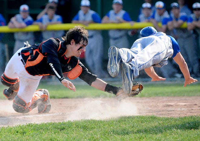 Freeport catcher Jack Lehnherr tags the foot of Marmion's Tyler Eberth for the out at home plate during the IHSA Class 3A Sycamore Sectional semifinal Wednesday.