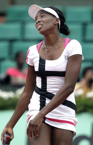 USA's Venus Williams reacts as she plays Poland's Agnieszka Radwanska during their second round match in the French Open tennis tournament at the Roland Garros stadium in Paris, Wednesday, May 30, 2012. (AP Photo/Michel Spingler)