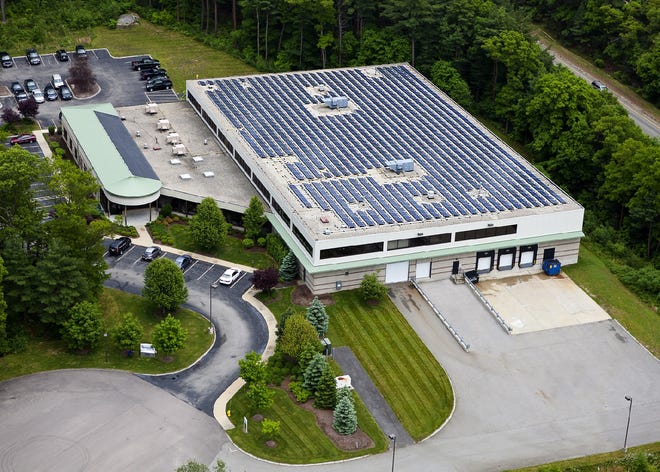An aerial view of American Plumbing and Heating in Norwell. The company recently invested in the rows of solar panels lining the rooftops.
