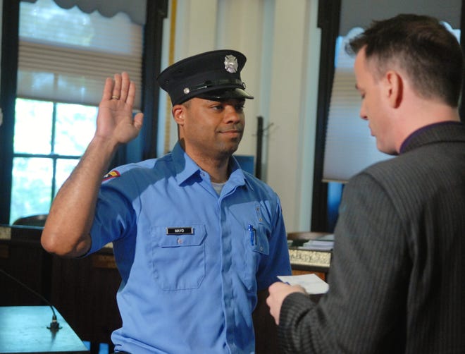 Alfred Mayo of Norwich is sworn in by New London Mayor Daryl Justin Finizio Friday at New London City Hall as the first black firefighter hired in New London since 1978. Mayo filed a racial discrimination complaint against the city and state fire academy after his firing in December. He was later rehired after an investigation turned up false allegations by fire academy instructors against him.