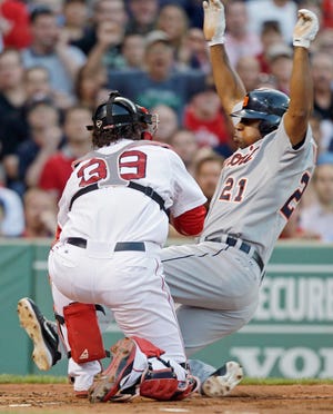 Detroit Tigers' Delmon Young, right, is caught at home by Boston Red Sox catcher Jarrod Saltalamacchia while trying to score on a fly out by Jhonny Peralta in the second inning of a baseball game at Fenway Park in Boston, Thursday, May 31, 2012. (AP Photo/Charles Krupa)