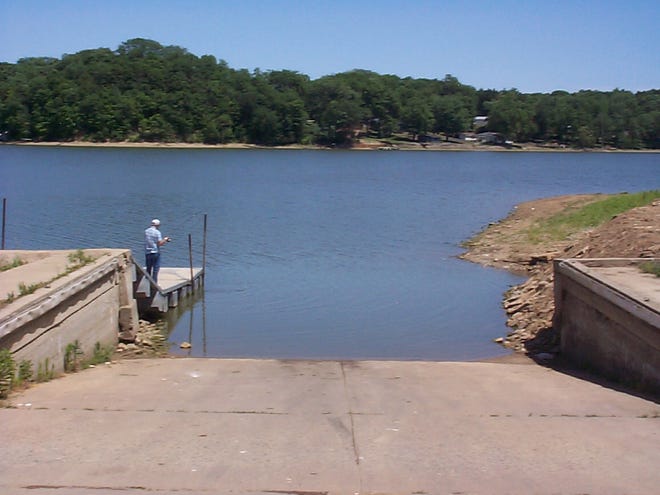 A Farmington man tries his luck fishing Tuesday at the north boat dock area at Canton Lake. He complained he was not catching many fish due to the low water level of the lake. There has been a rather dry spell in recent weeks, but rain fell steadily on Thursday.