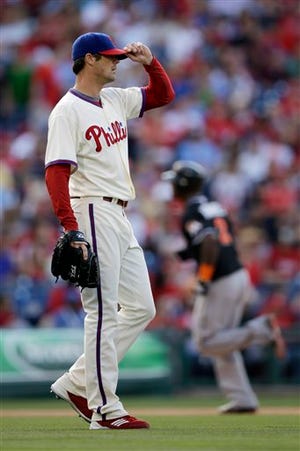By Kevin Cooney/Staff writer 
 Philadelphia Phillies starting pitcher Cole Hamels, left, adjusts his hat after giving up a two-run home run to Miami Marlins’ Hanley Ramirez in the sixth inning of a baseball game, Saturday, June 2, 2012, in Philadelphia. Miami won 5-4.