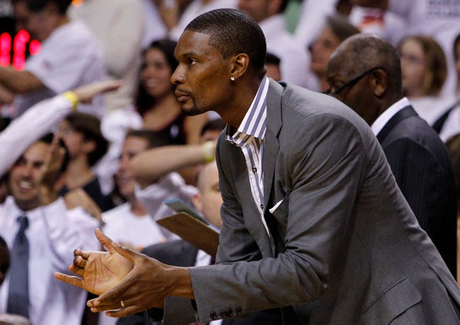 Miami's Chris Bosh watches from the bench during Game 2 of the Eastern Conference finals between the Celtics and Heat.