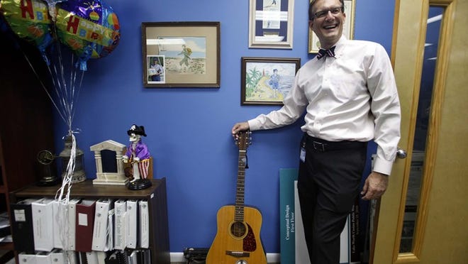 Michael Bornstein, the new city manager of Lake Worth, painted his office deep blue and added quirky touches such as his guitar, a mounted wahoo and a talking toy pirate. The changes reflect Bornstein’s passions for music, fishing and Florida history.