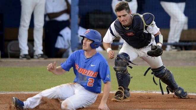 Florida's Casey Turgeon (2) slides into home safely as Georgia Tech's Zane Evans is unable to tag during an NCAA college baseball tournament regional game in Gainesville, Fla., Saturday, June 2, 2012. Florida defeated Georgia Tech 6-2. (AP Photo/Phil Sandlin)
