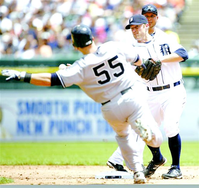 Detroit Tigers second baseman Danny Worth, center, turns the ball after getting a force-out on New York Yankees' Russell Martin (55) as shortstop Jhonny Peralta, right, look on in the second inning of baseball game on Sunday, June 3, 2012, in Detroit. Yankees' Derek Jeter hit into the double play and was out at first base.