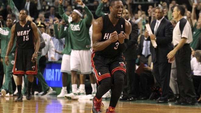 Dwyane Wade (3) reacts after missing a 3-point attempt just before the final buzzer in overtime as the Heat falls 93-91 to the Celtics in Game 4 of the East finals.