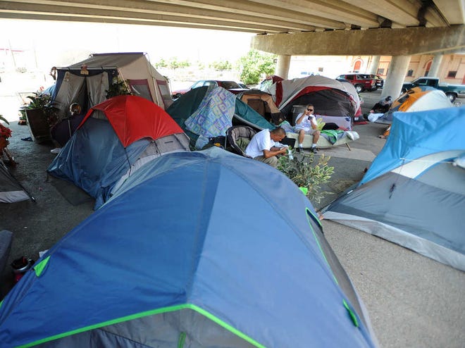 Several tents are set up under the South Pierce Street overpass near East First Avenue.